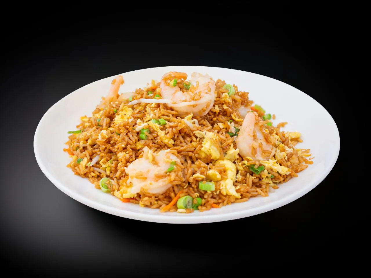 Shrimp fried rice mixed with scrambled egg, carrot and green scallions